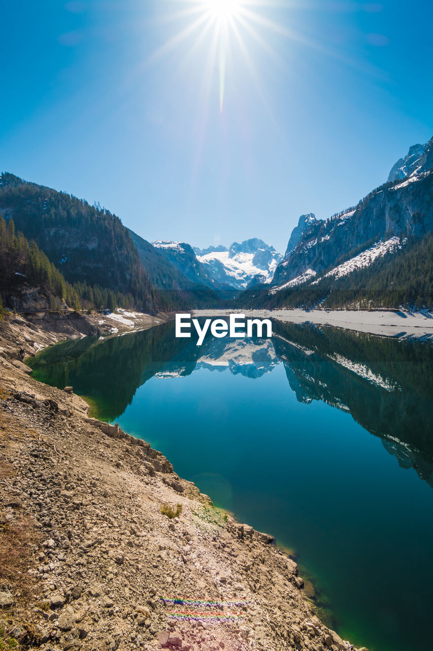 Scenic view of lake and mountains against sky