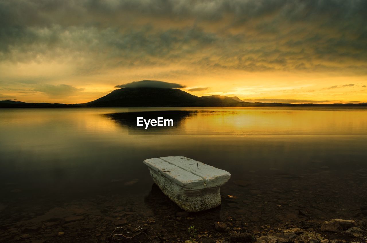 Scenic view of lake against sky during sunset