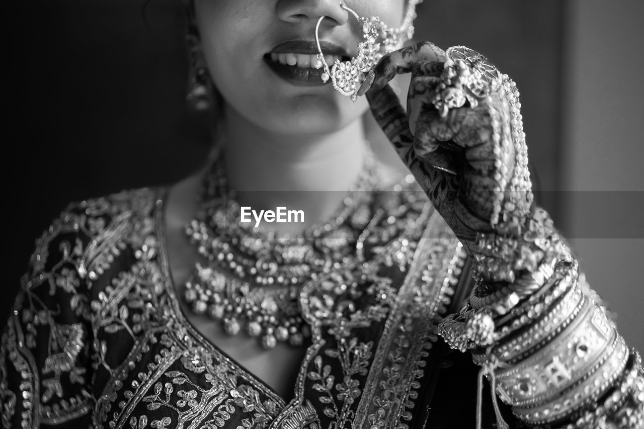 one person, adult, women, indoors, portrait, jewelry, fashion, black and white, person, clothing, female, young adult, headshot, studio shot, monochrome photography, emotion, monochrome, happiness, photo shoot, lifestyles, celebration, smiling, arts culture and entertainment, traditional clothing