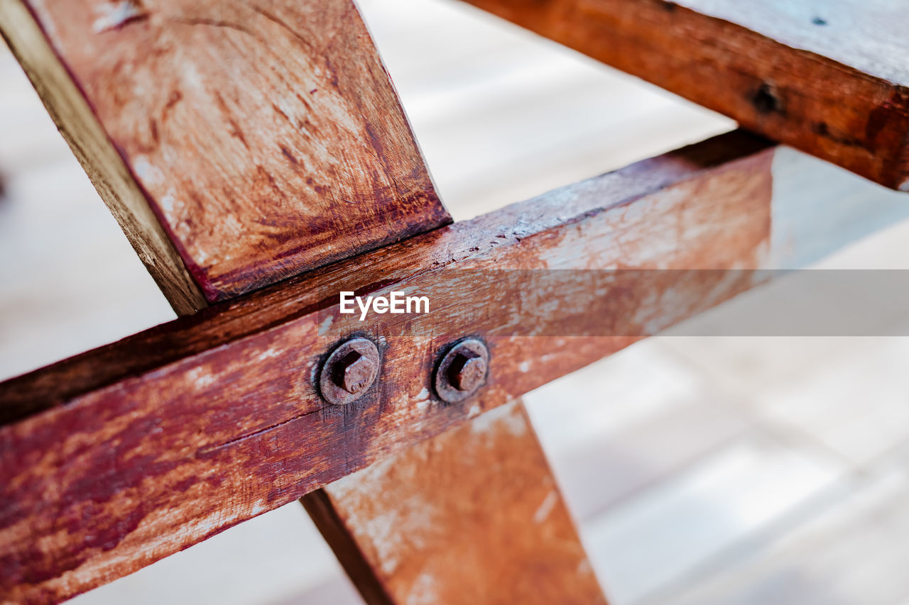 Close up wooden table rivets on the picnic stool furniture.