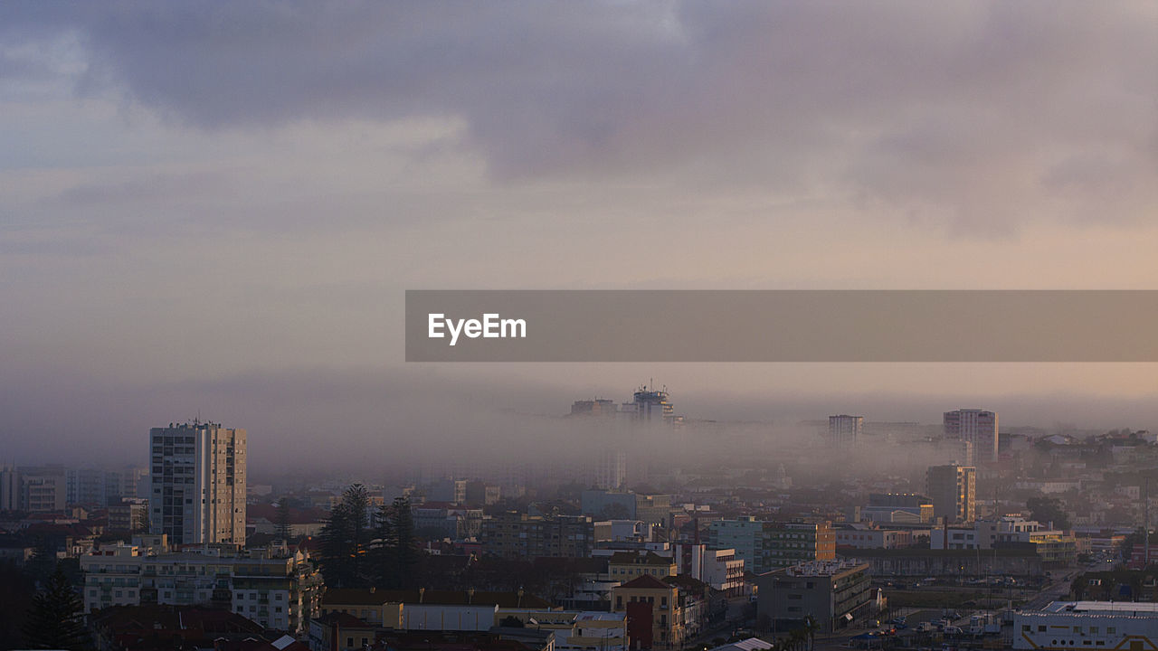 Cityscape against sky during foggy weather