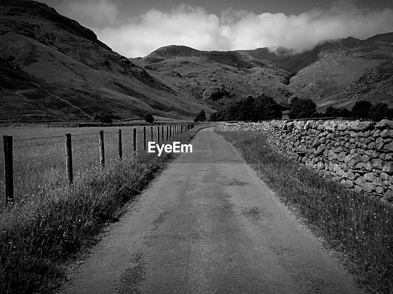 Empty road leading towards mountains