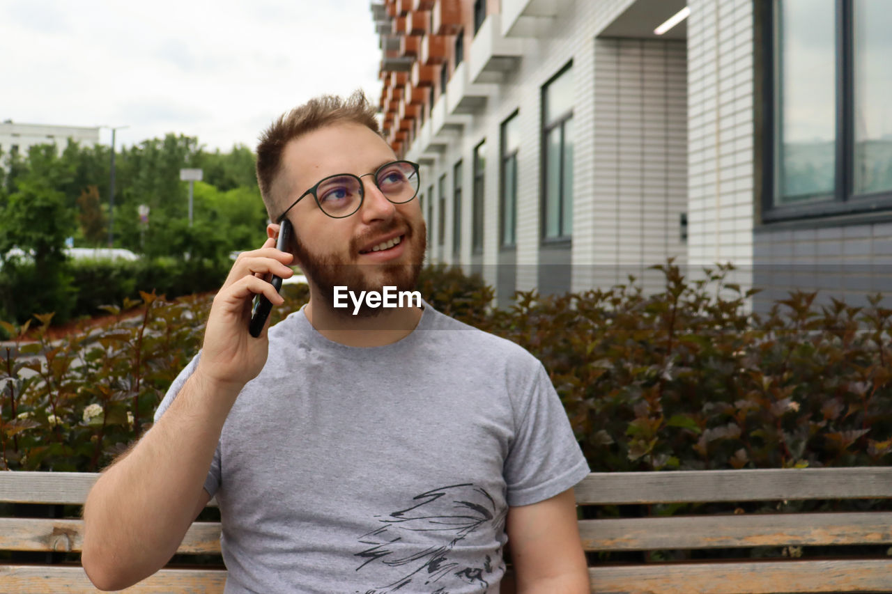 Portrait of young man using mobile phone