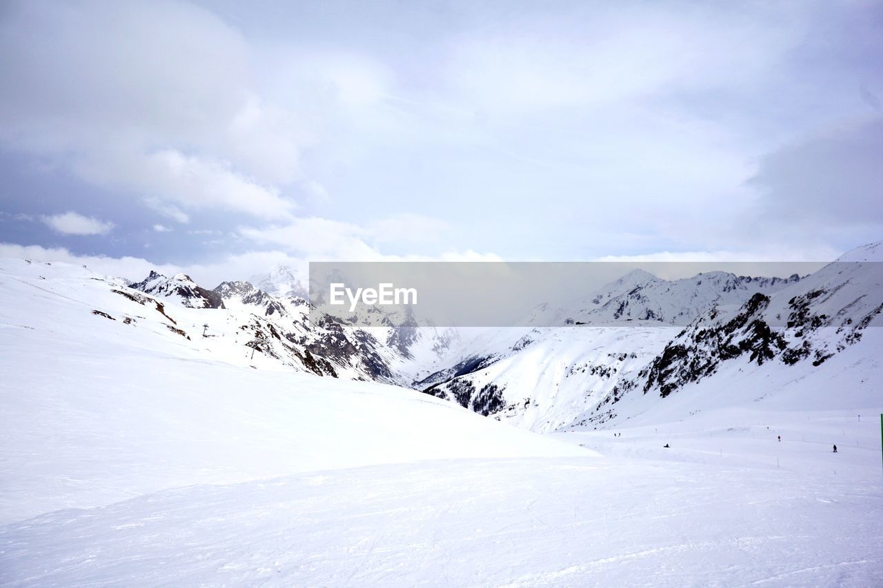 Scenic view of mountains against sky during winter