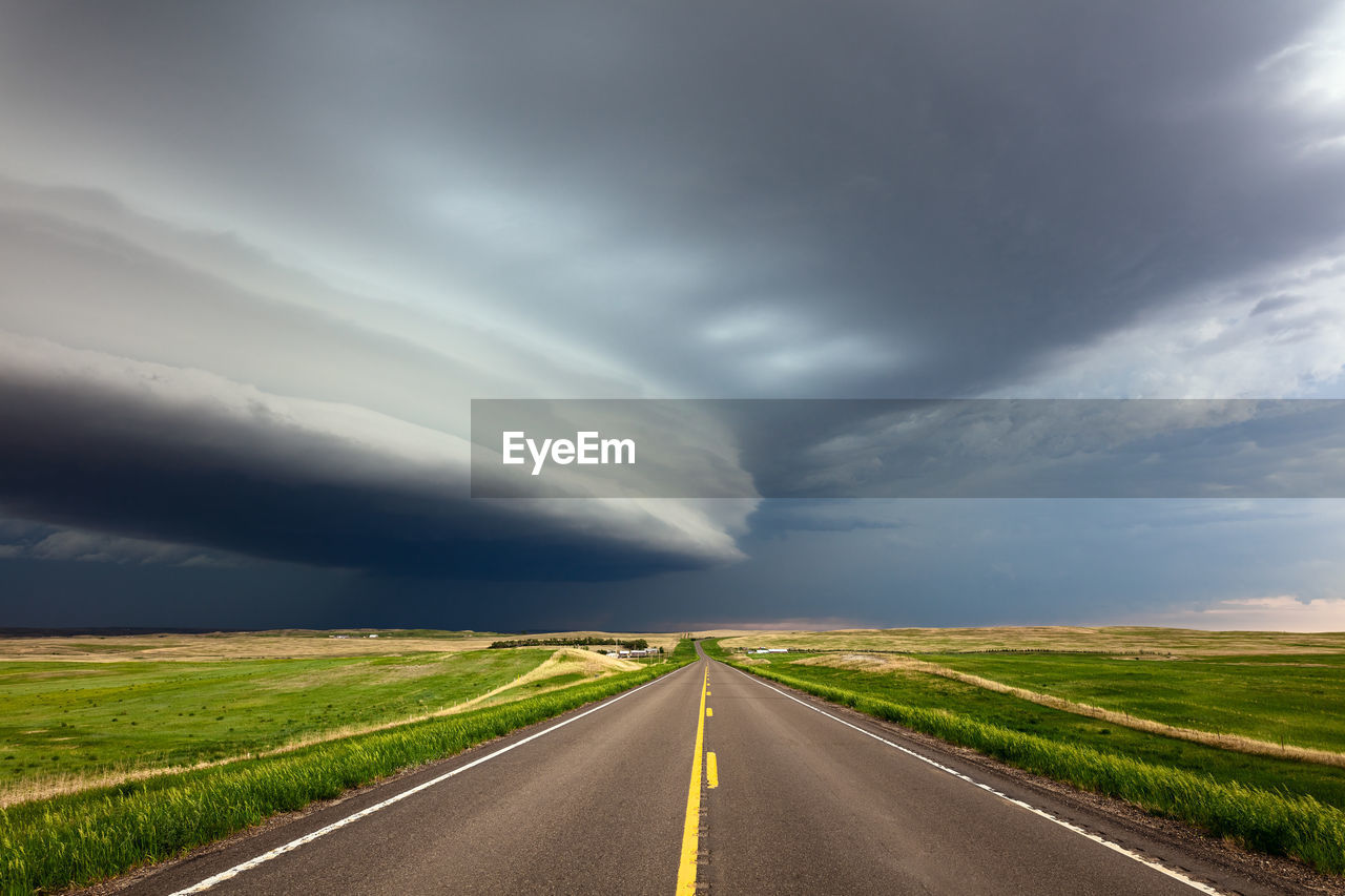 Straight road with dramatic storm clouds in montana