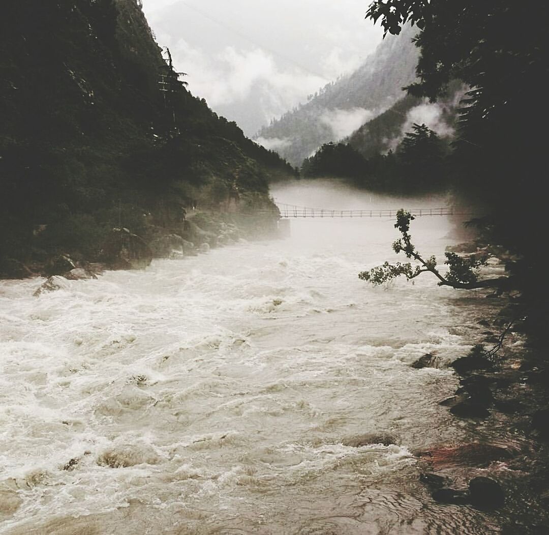 Stream flowing amidst mountains