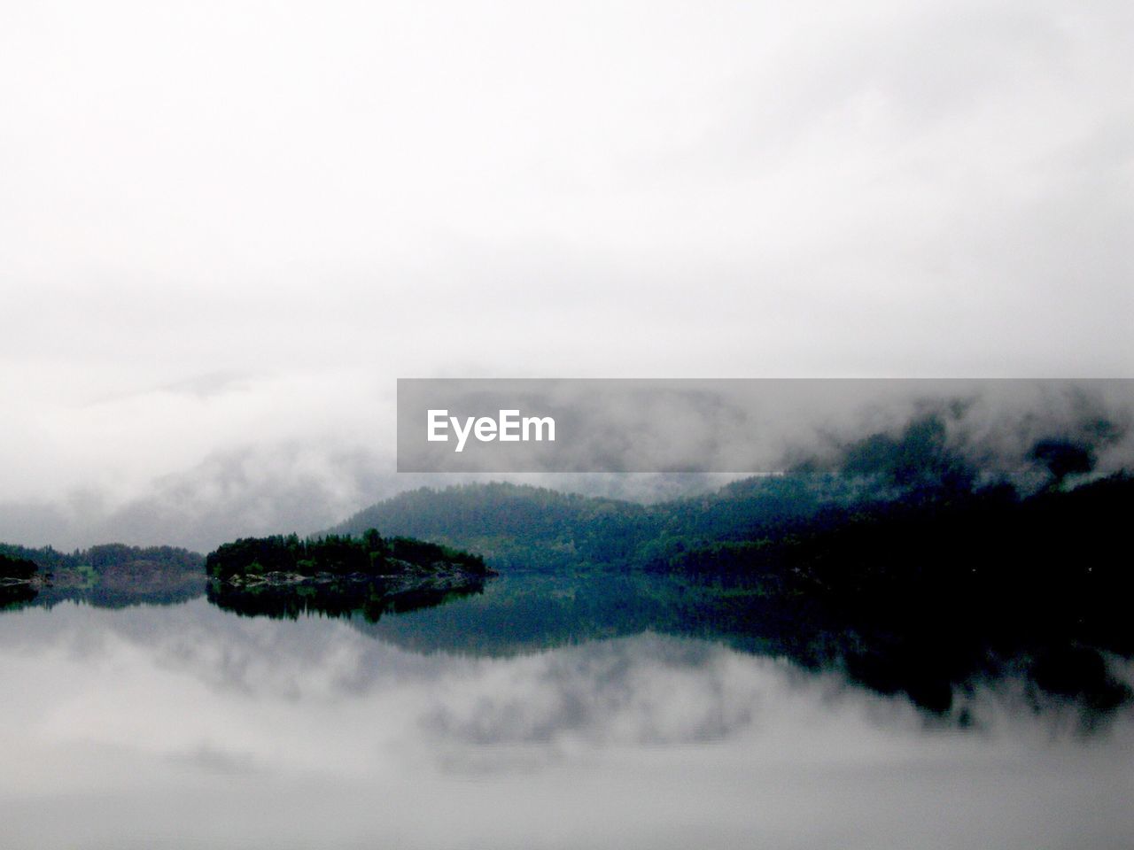 Scenic view of mountains against cloudy sky