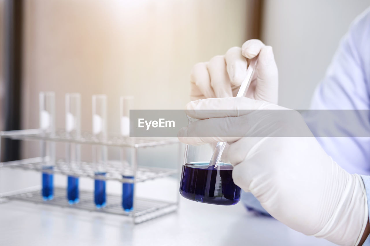 Cropped hand of scientist working in laboratory