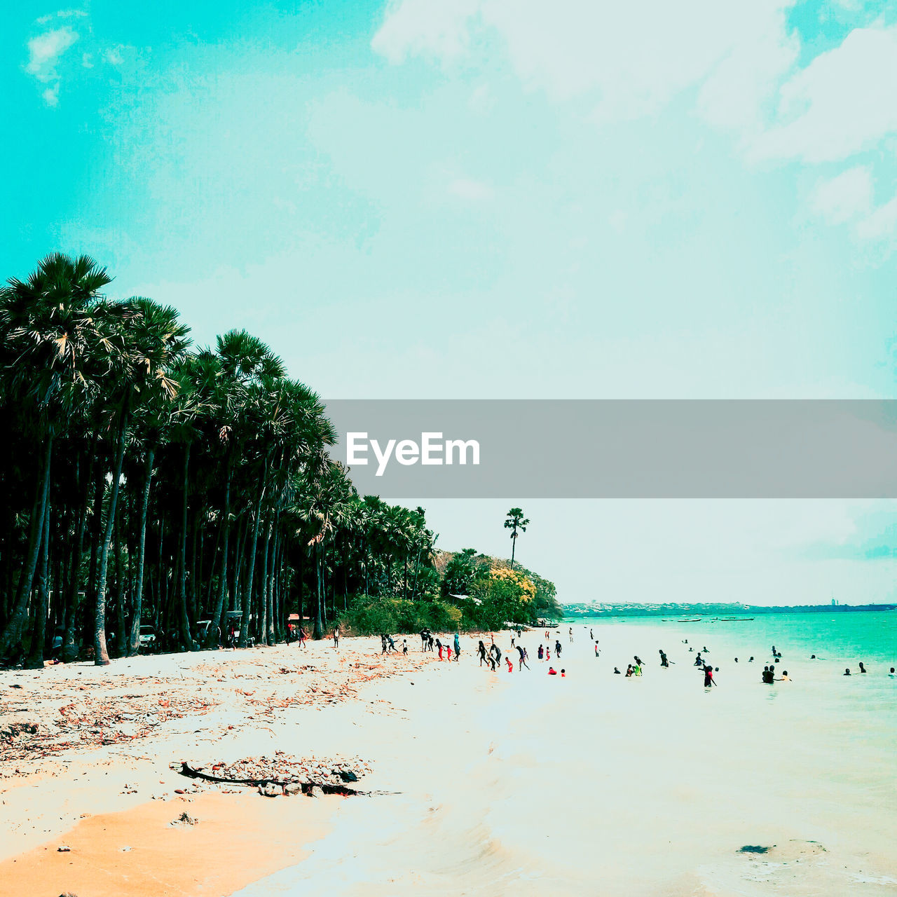 REAR VIEW OF PEOPLE ON BEACH