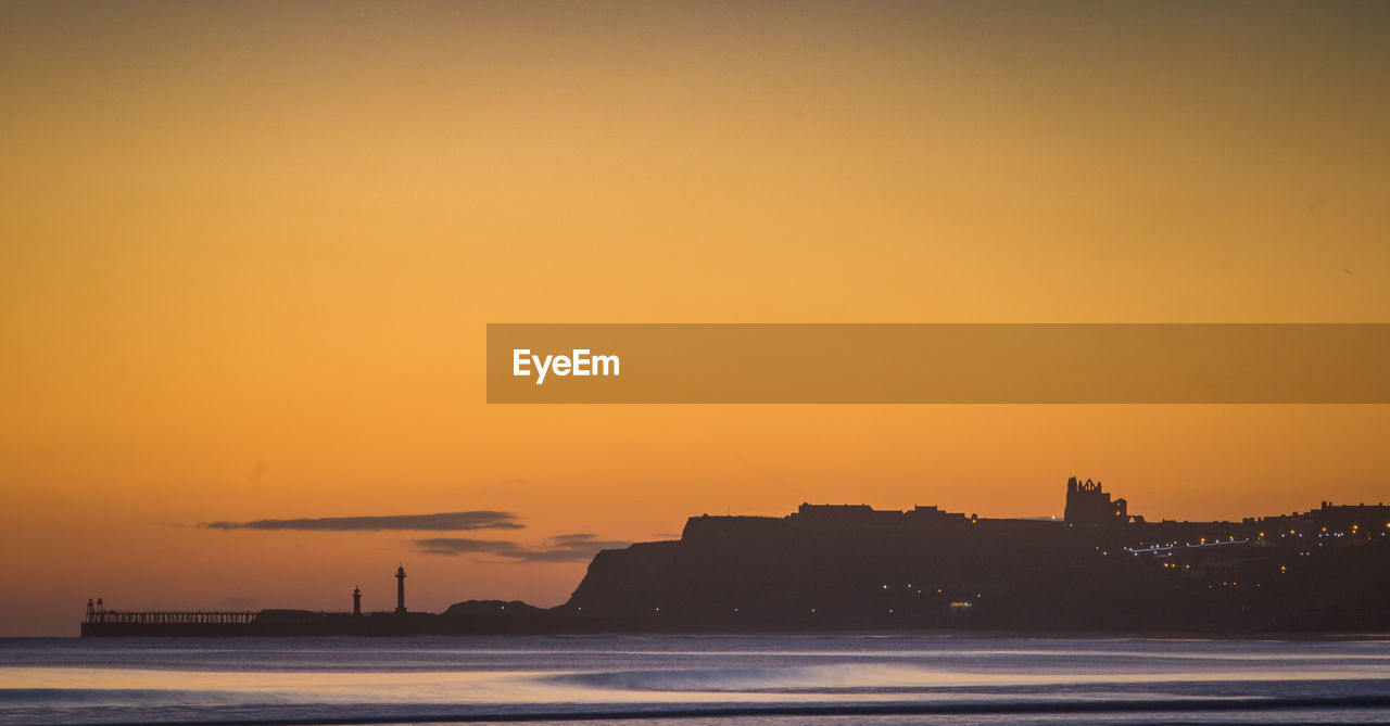 Scenic view of sea against romantic sky at sunset whitby sunrise