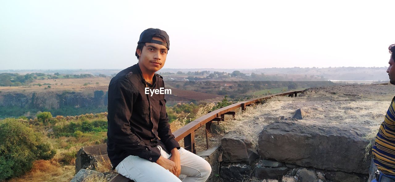 Portrait of young man against mountain