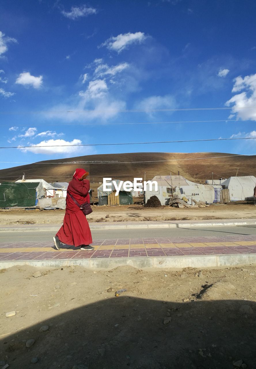 WOMAN STANDING ON DESERT