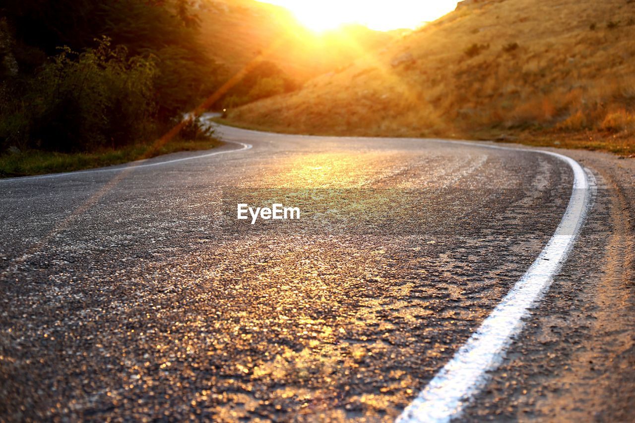 ROAD PASSING THROUGH STREET DURING SUNSET