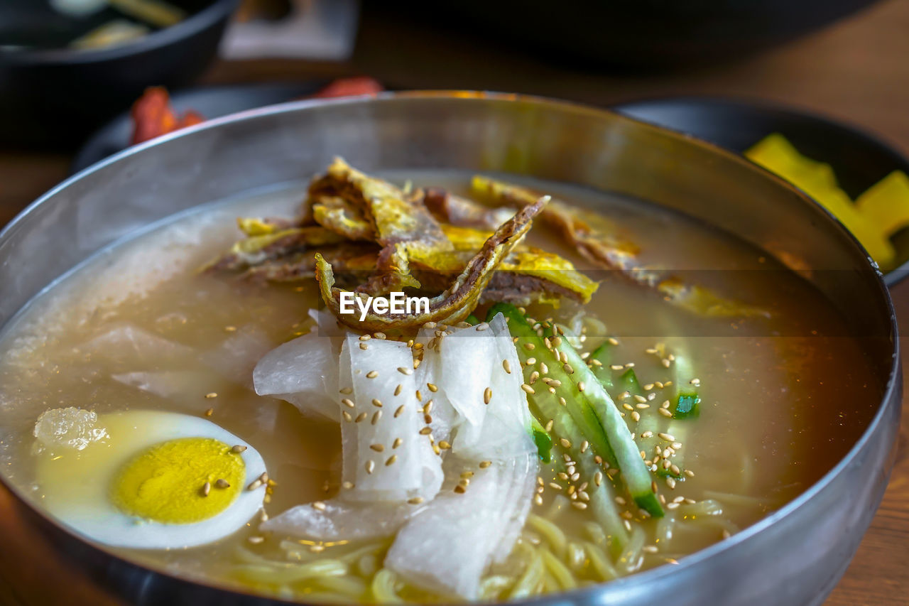 CLOSE-UP OF SOUP IN BOWL ON TABLE