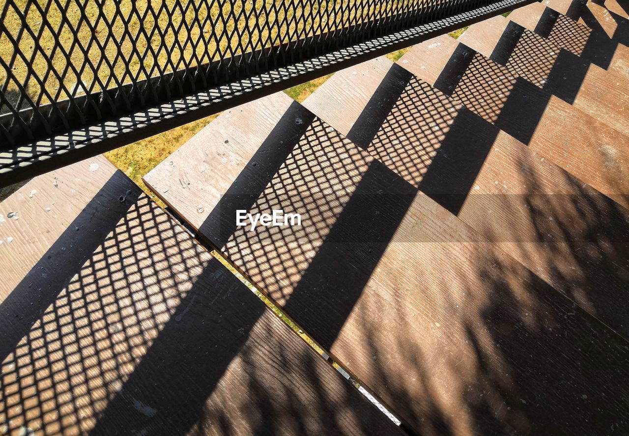 Shadow of railing on footpath