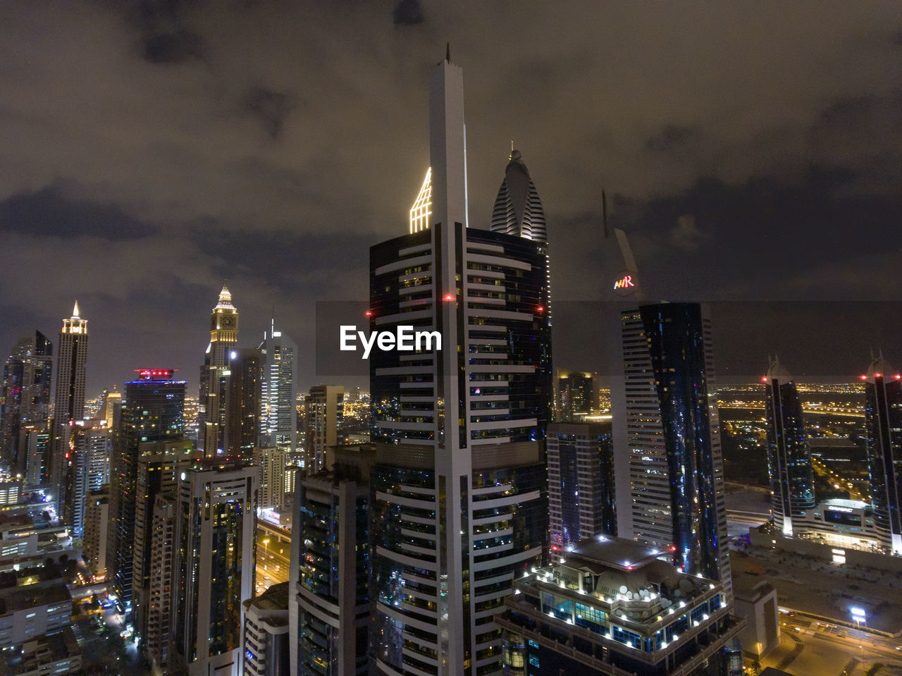 AERIAL VIEW OF ILLUMINATED BUILDINGS AGAINST SKY