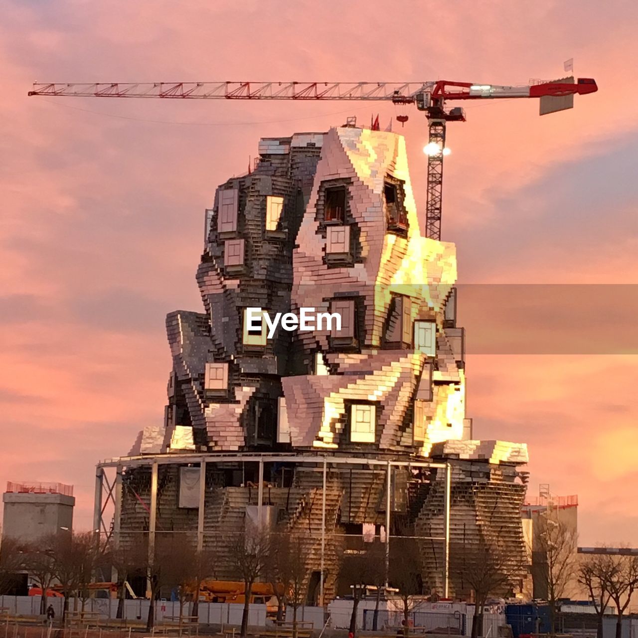 LOW ANGLE VIEW OF BUILDING AT CONSTRUCTION SITE DURING SUNSET