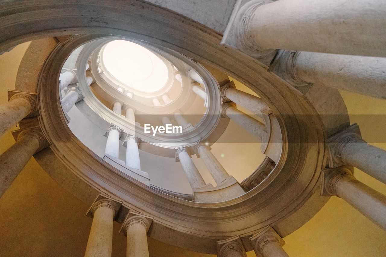 DIRECTLY BELOW SHOT OF SPIRAL STAIRCASE IN BUILDING