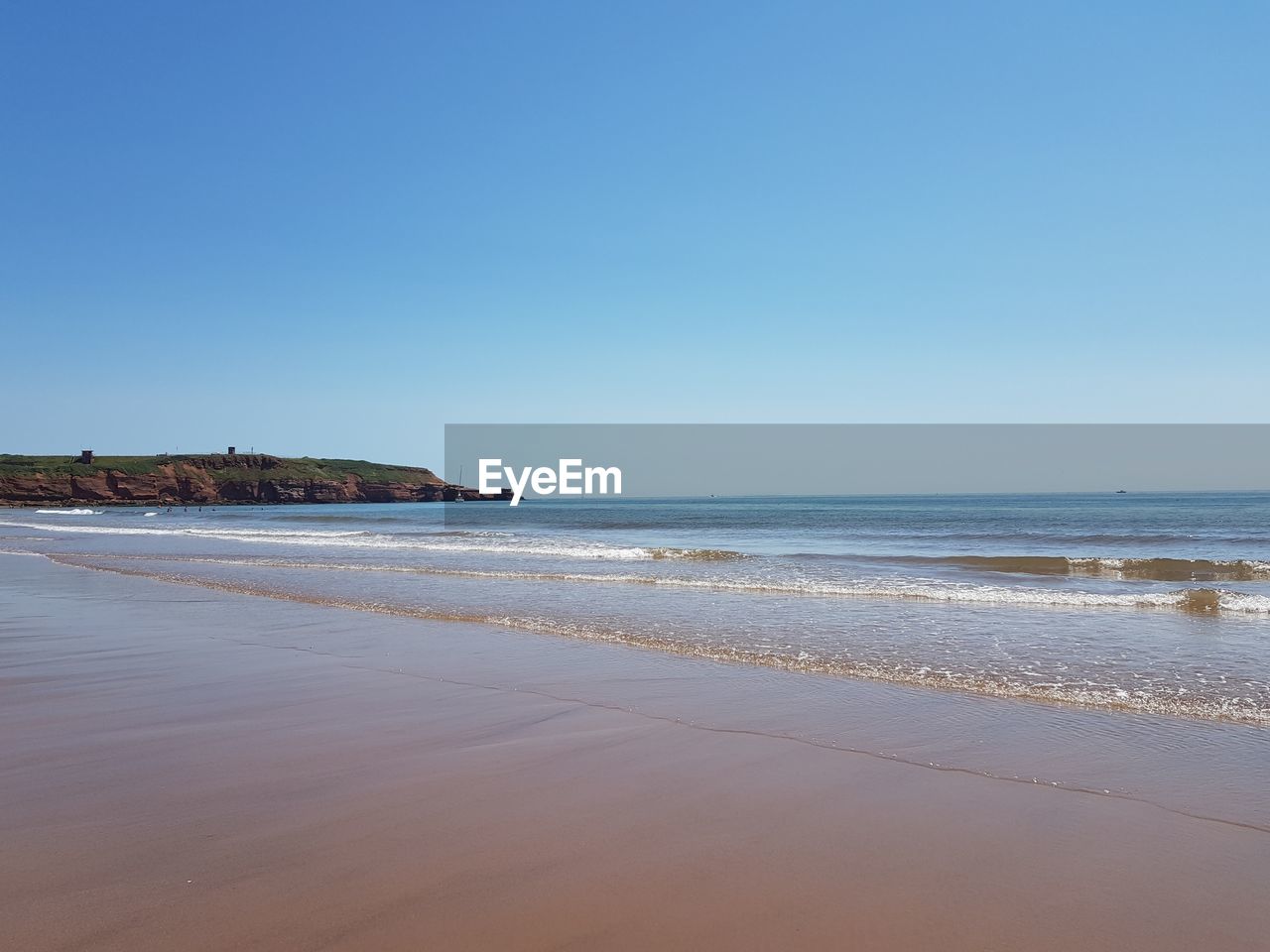 Scenic view of beach against clear sky