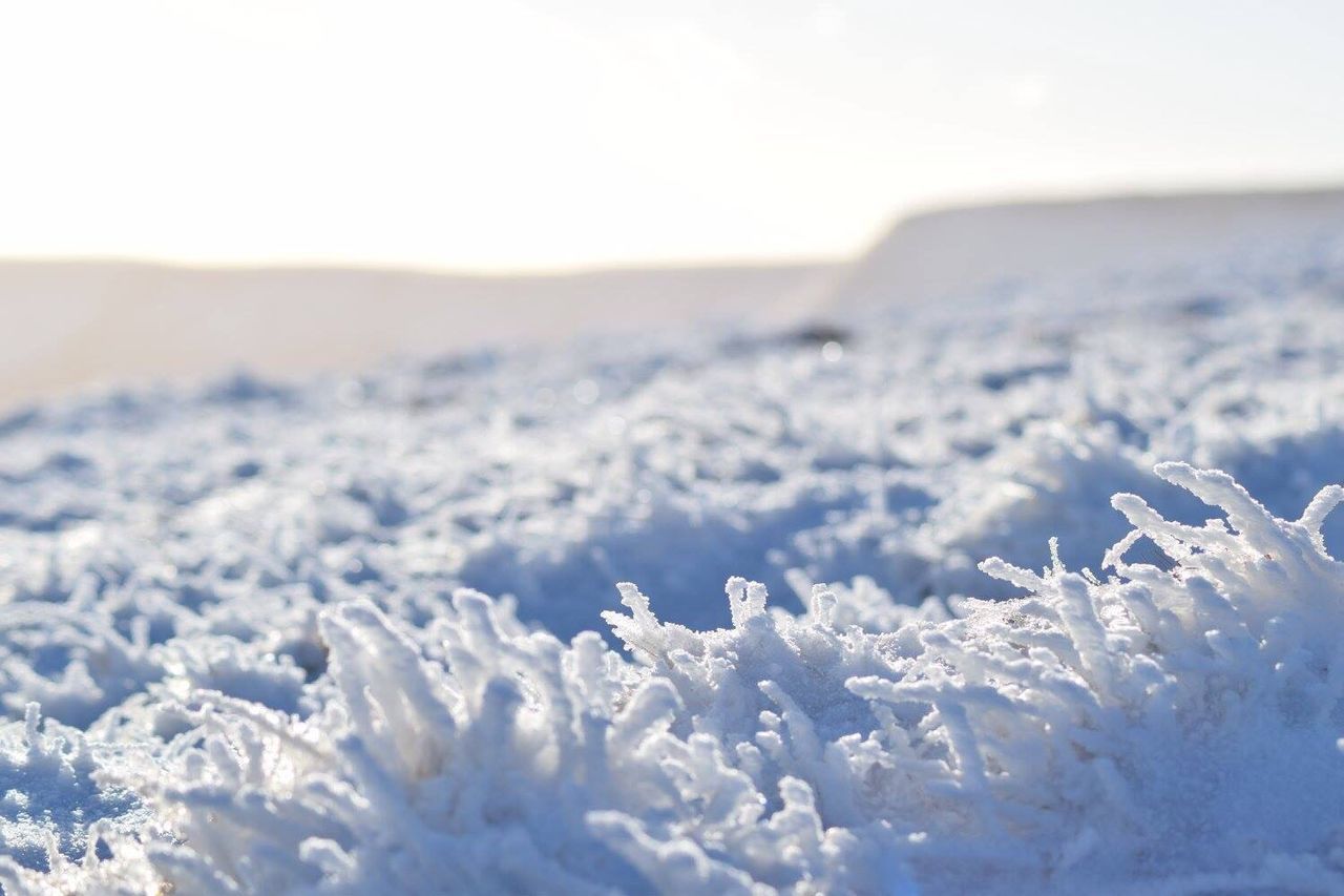 Snow covered landscape against the sky