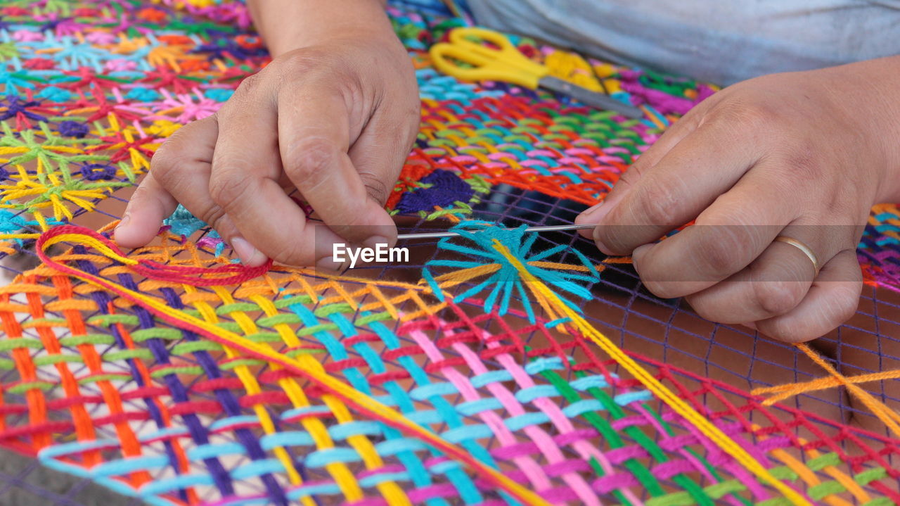 Cropped image of person making crochet