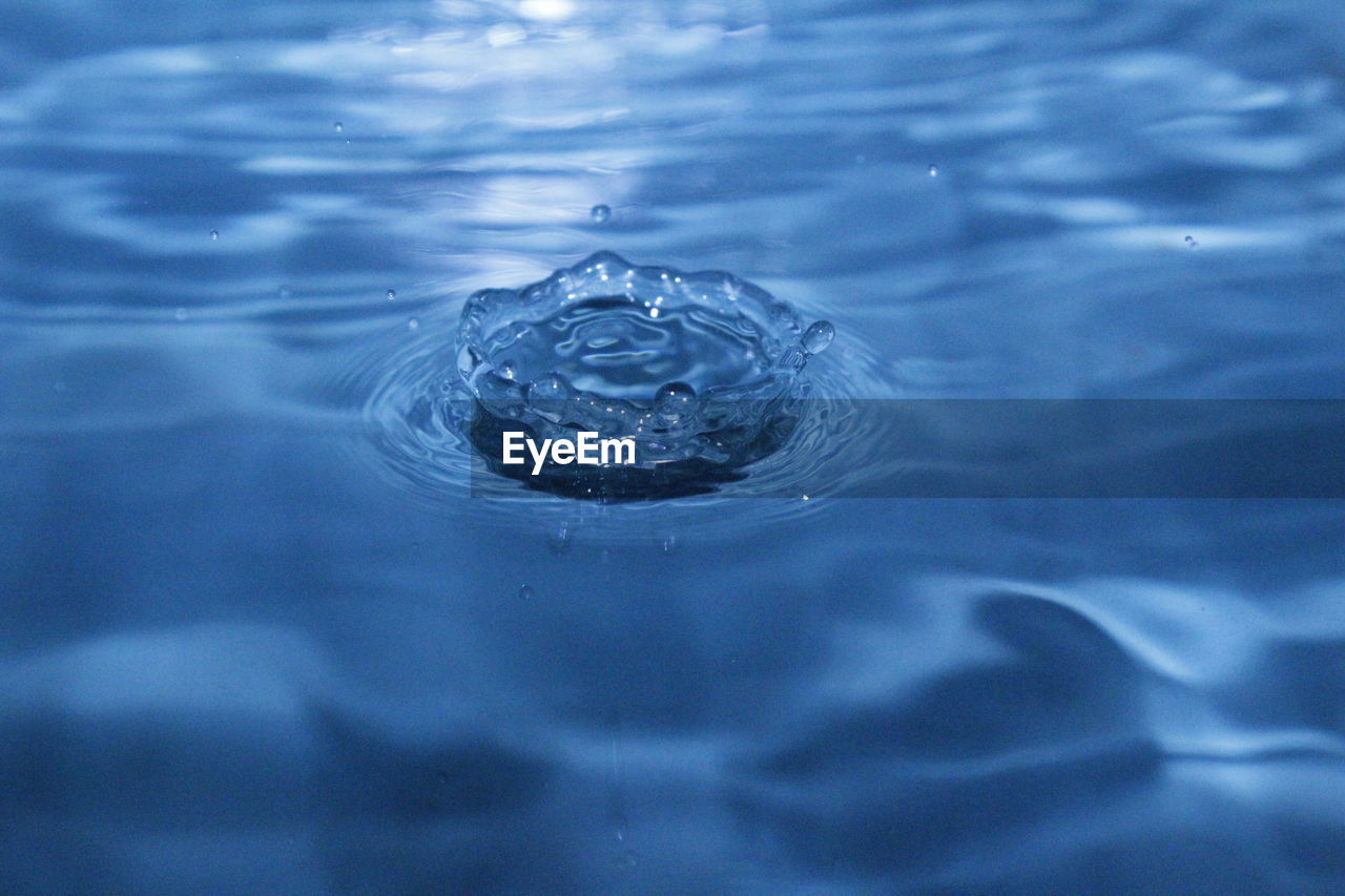 High angle view of drop falling on water