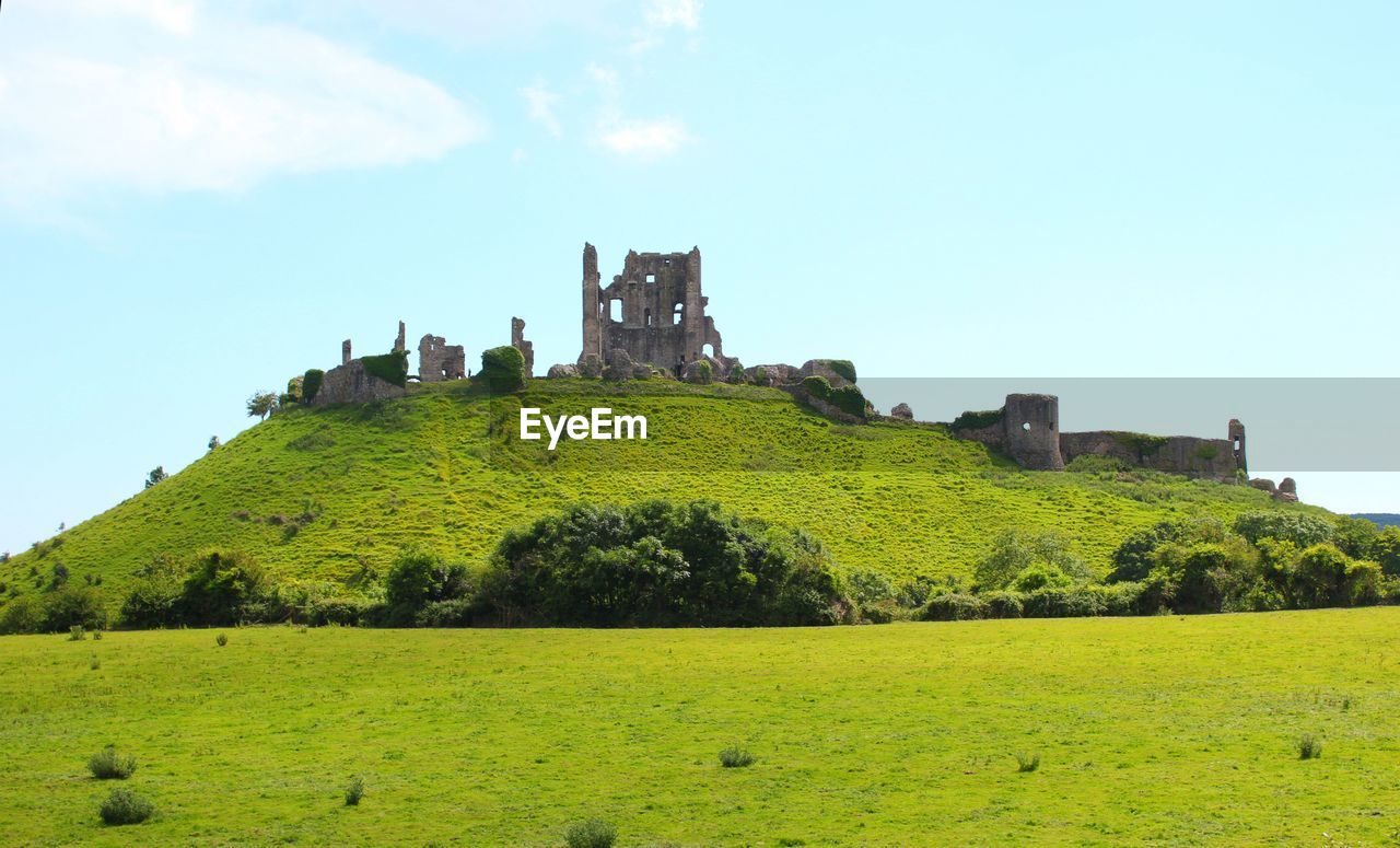 Scenic view of castle ruins on hill against sky