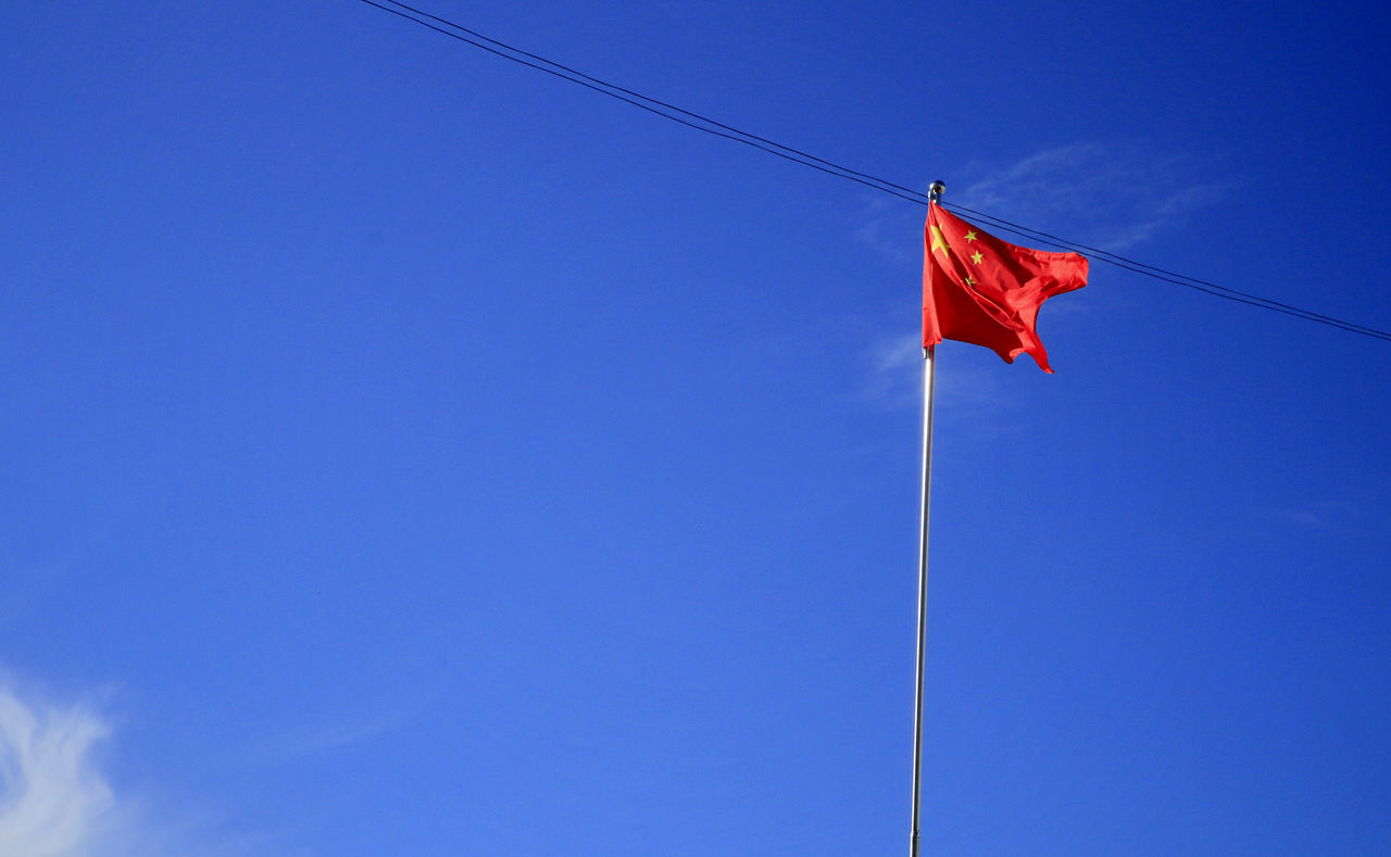 LOW ANGLE VIEW OF FLAG AGAINST BLUE SKY