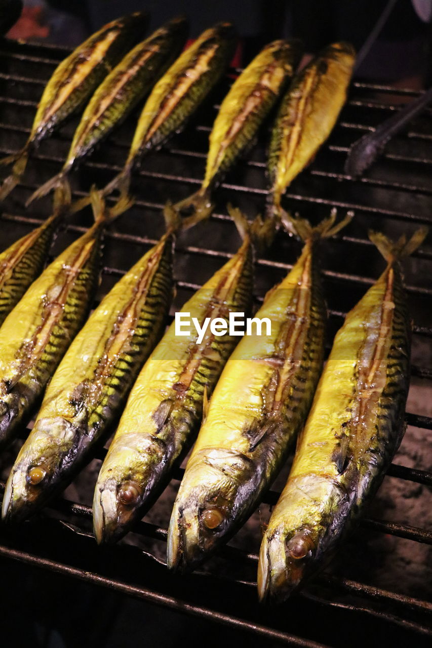 High angle view of fishes on barbecue grill