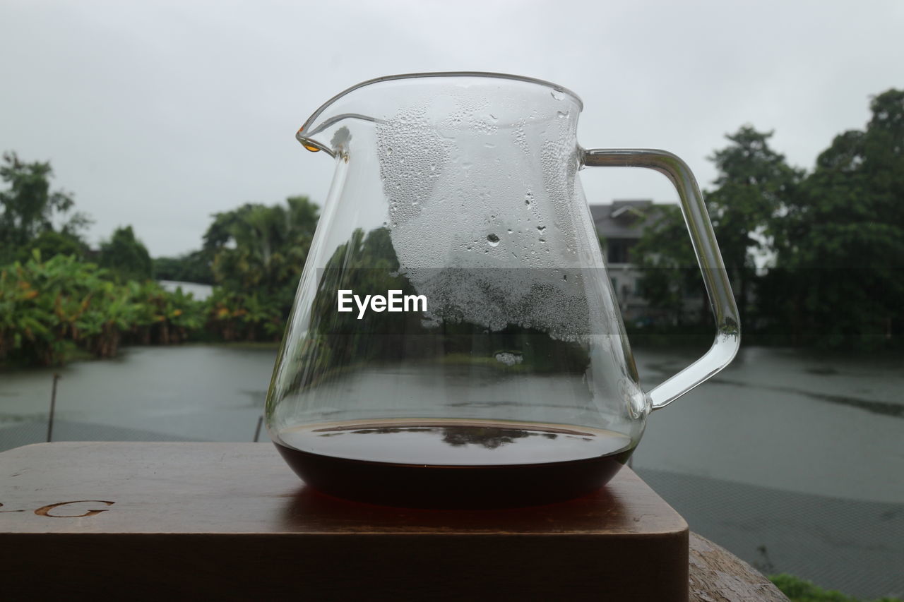 drink, food and drink, refreshment, water, nature, table, plant, no people, glass, household equipment, tree, pitcher - jug, kettle, day, outdoors, drinking glass, jug, tableware, tea, close-up, sky, food, transparent