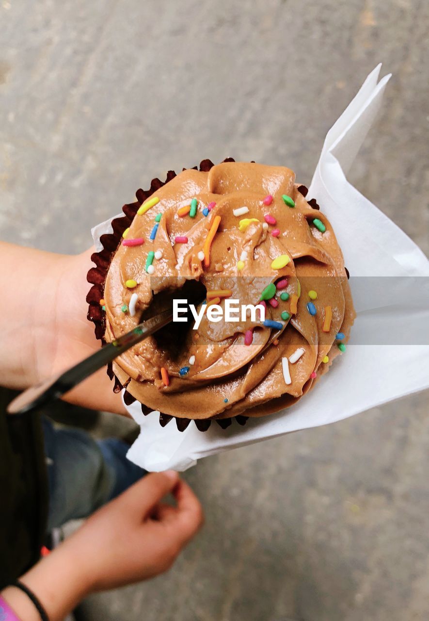 High angle view of hand holding ice cream