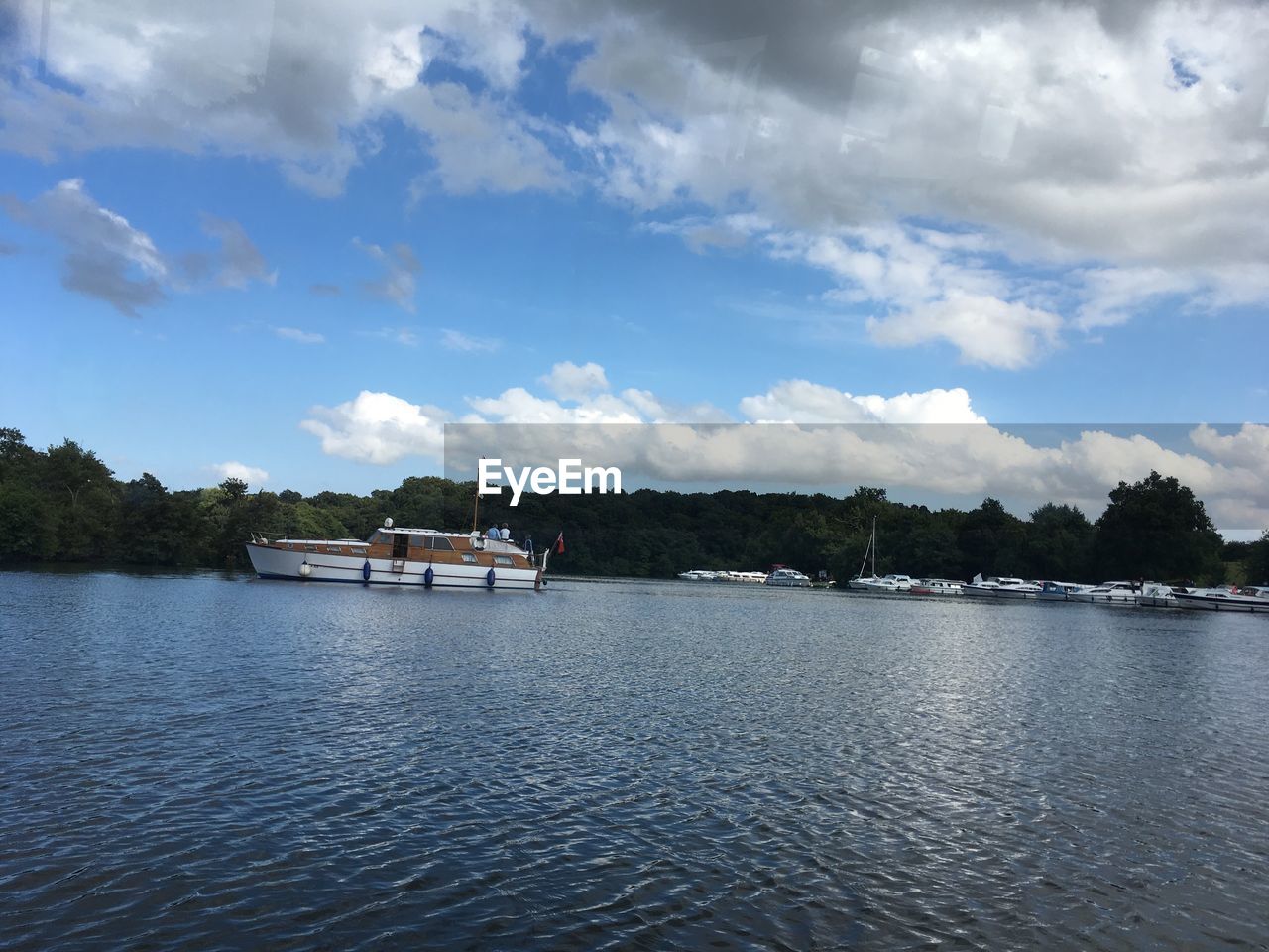 BOATS IN RIVER AGAINST SKY