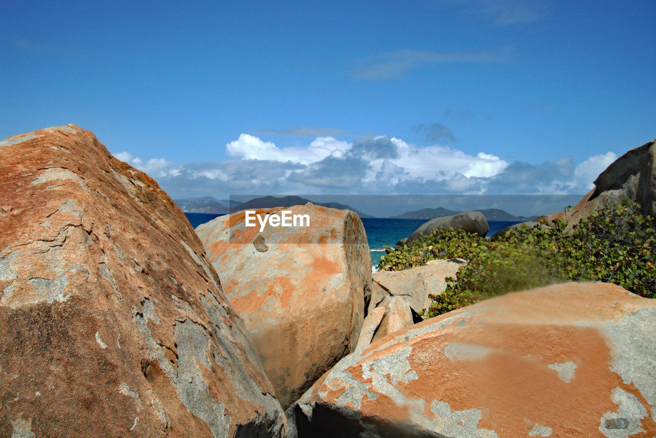 Panoramic view of rocks and mountains against blue sky