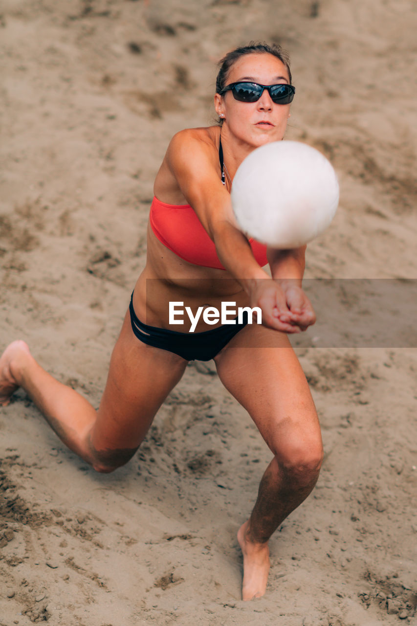 Beach volleyball player hitting the ball