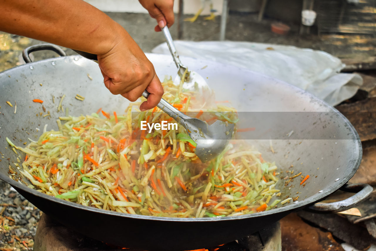 Cropped image of person preparing food