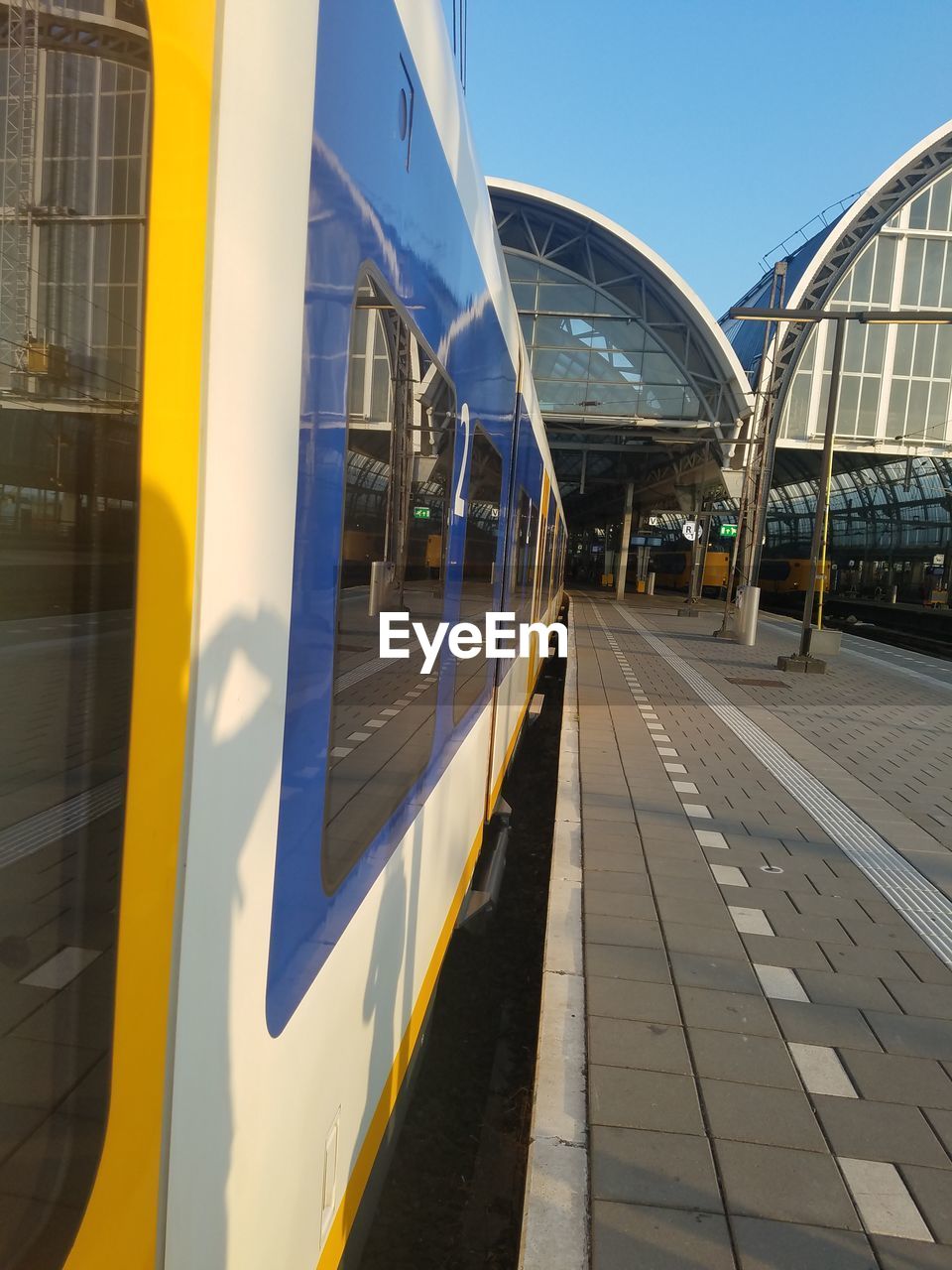 Train at railroad station against clear sky