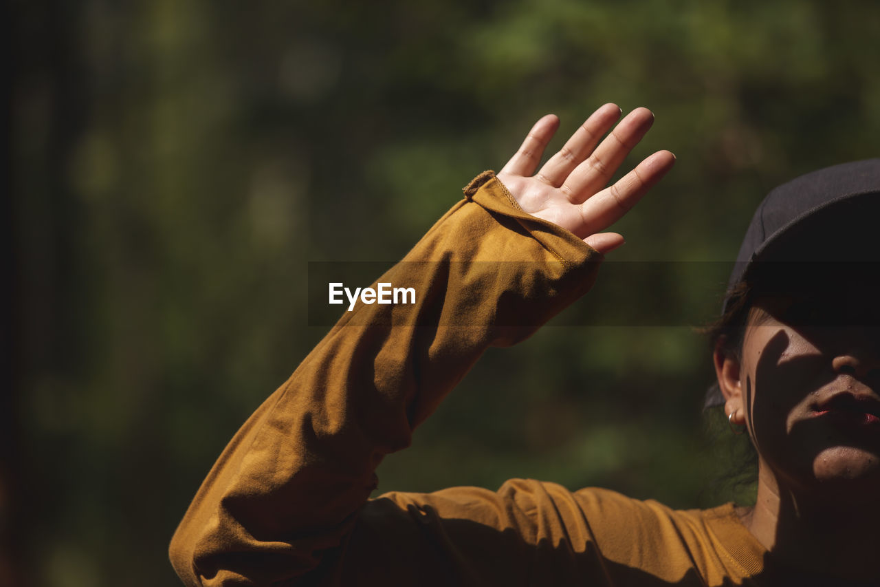 Close-up of woman gesturing outdoors