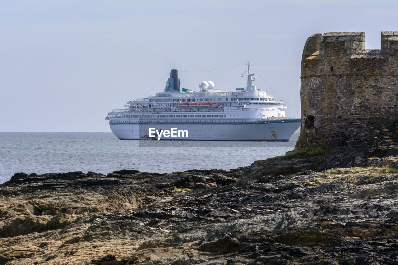 SHIP SAILING IN SEA AGAINST CLEAR SKY