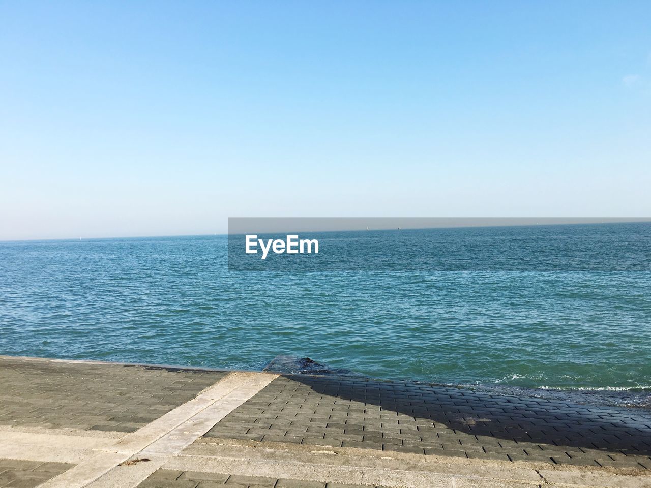 Scenic view of calm sea against clear sky