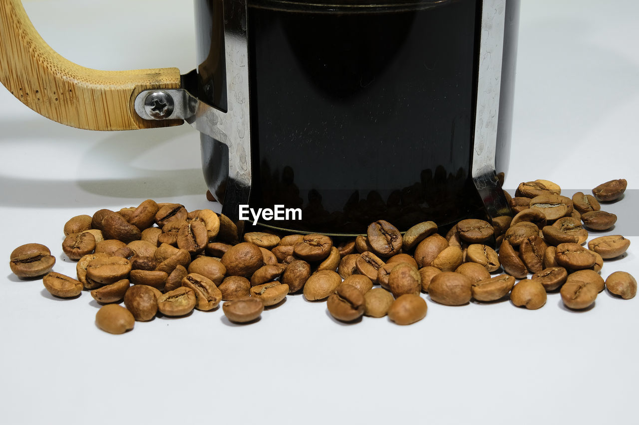 CLOSE-UP OF COFFEE BEANS IN BACKGROUND