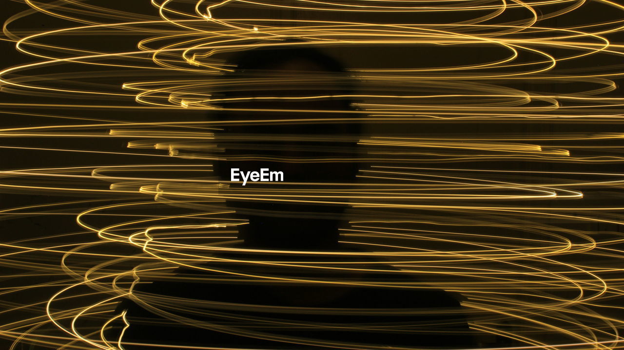 Light painting abstract colorful irregular lines on black background photo with long exposure.