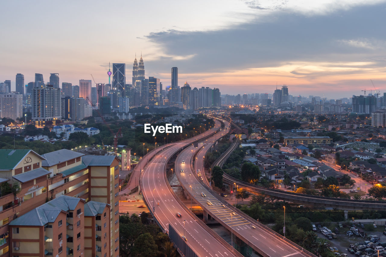 High angle view of illuminated cityscape during sunset