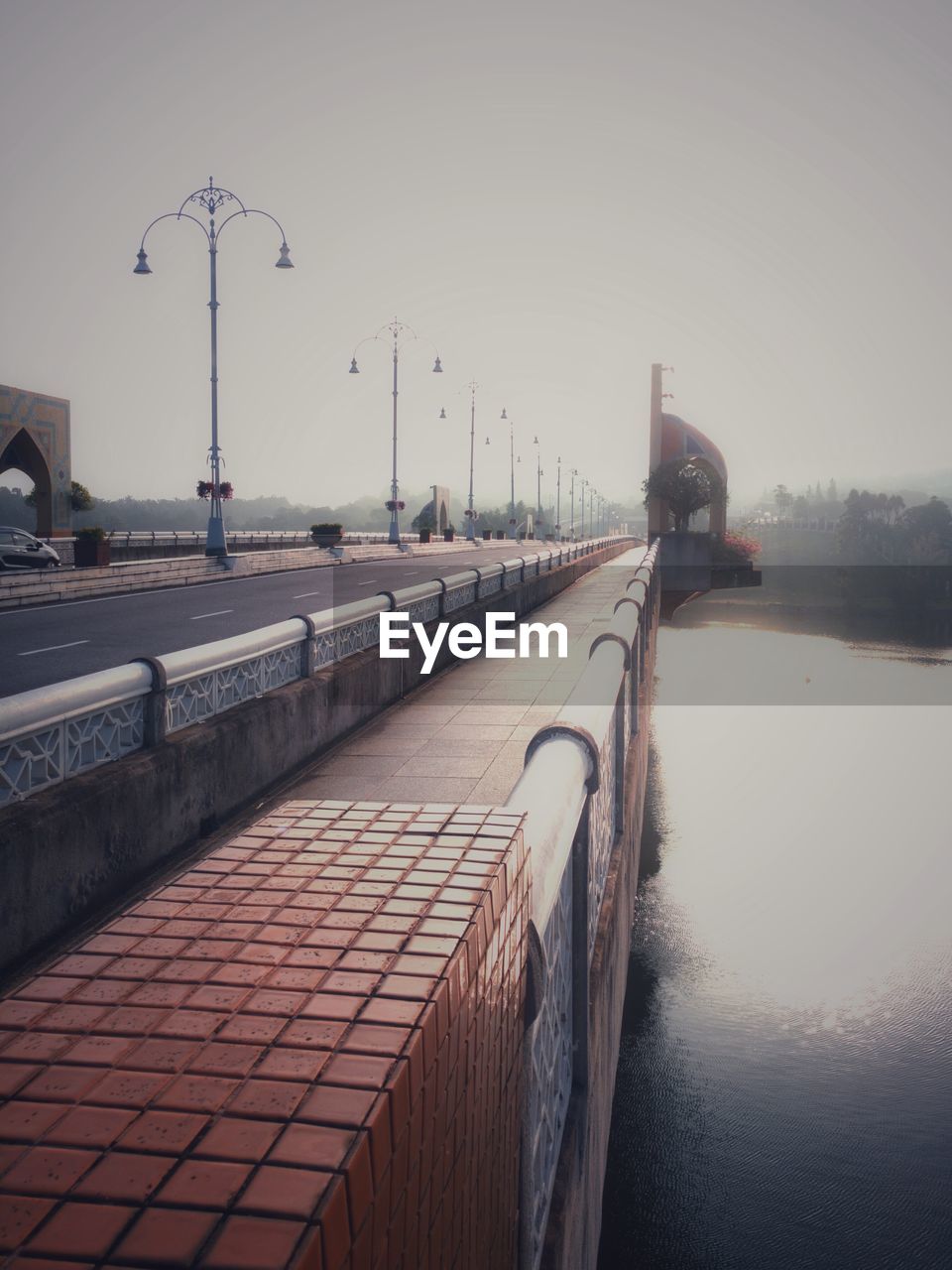 VIEW OF BRIDGE OVER CALM RIVER