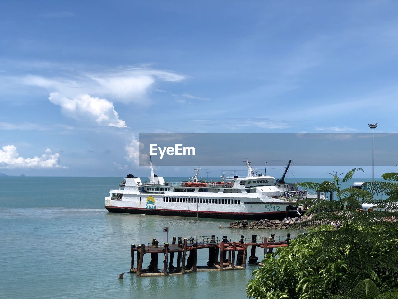 SHIP MOORED AT SEA AGAINST SKY