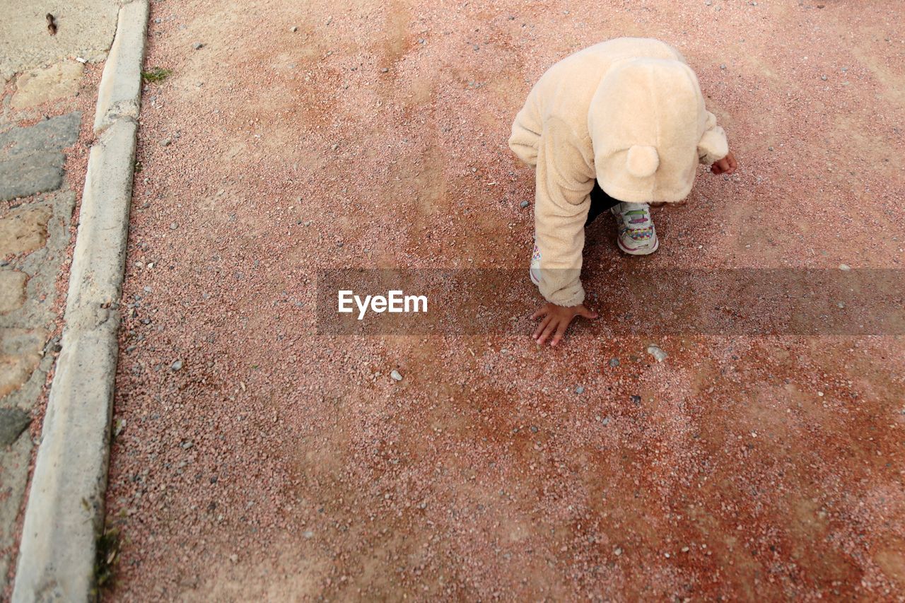 High angle view of baby girl on land during winter