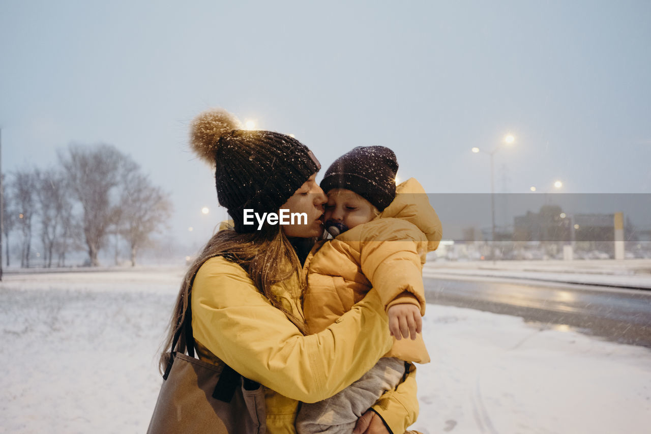 FRIENDS STANDING ON SNOW