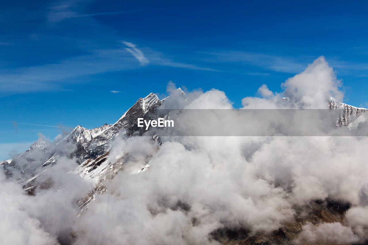 Aerial view of snowcapped mountain against sky