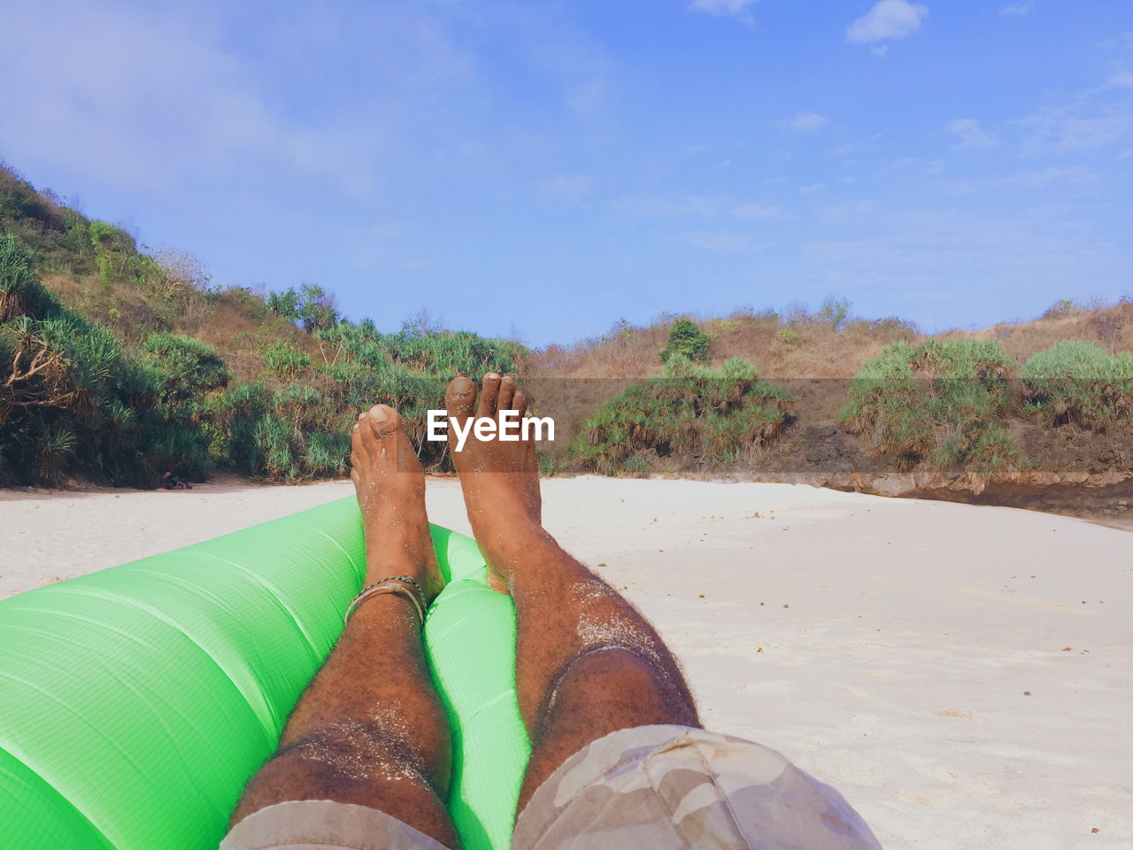 human leg, low section, personal perspective, one person, nature, vacation, water, land, human limb, limb, leisure activity, adult, holiday, sand, trip, sea, lifestyles, relaxation, sky, human foot, day, beach, barefoot, shoe, outdoors, plant, scenics - nature, travel, beauty in nature, travel destinations, environment, tranquility, shore, sunlight, men, women, tree, green, legs crossed at ankle