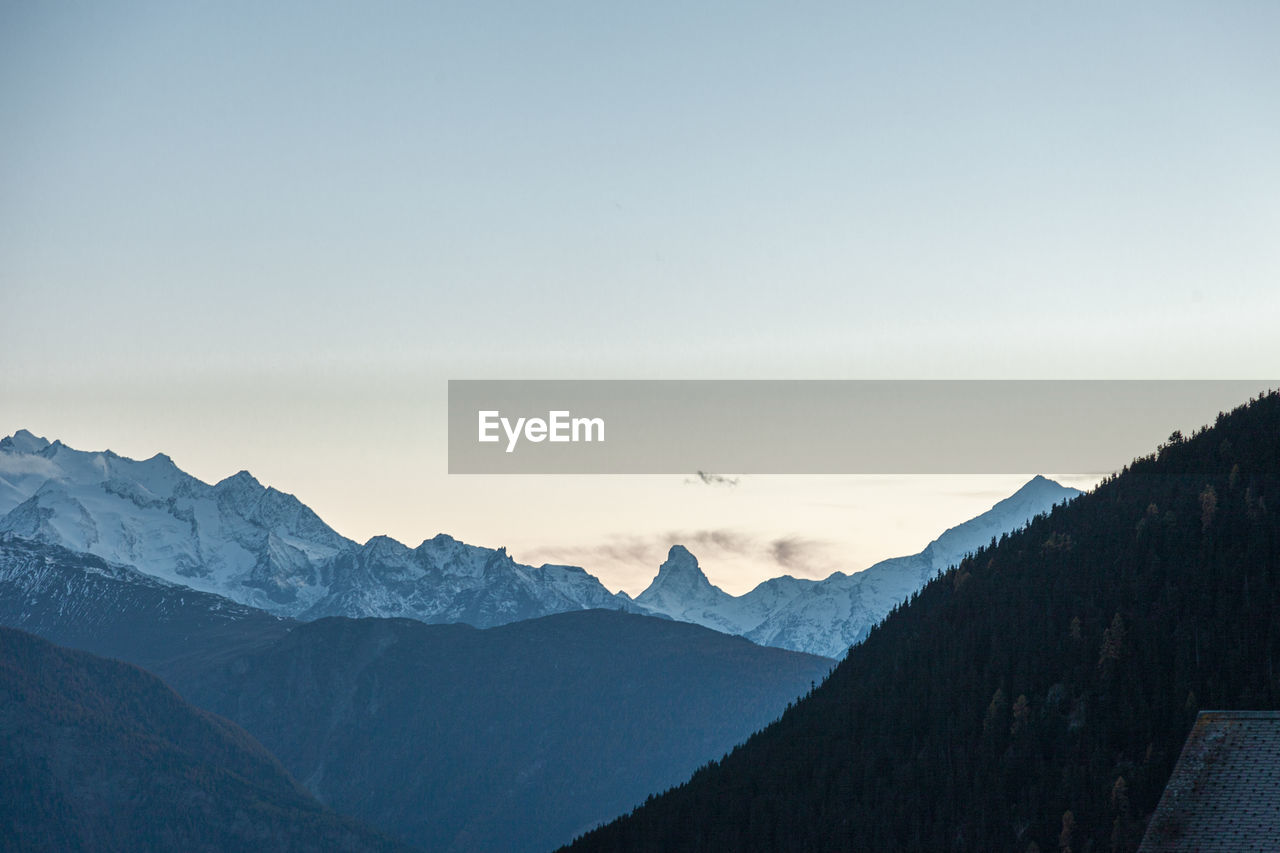 Scenic view of mountains against sky during winter