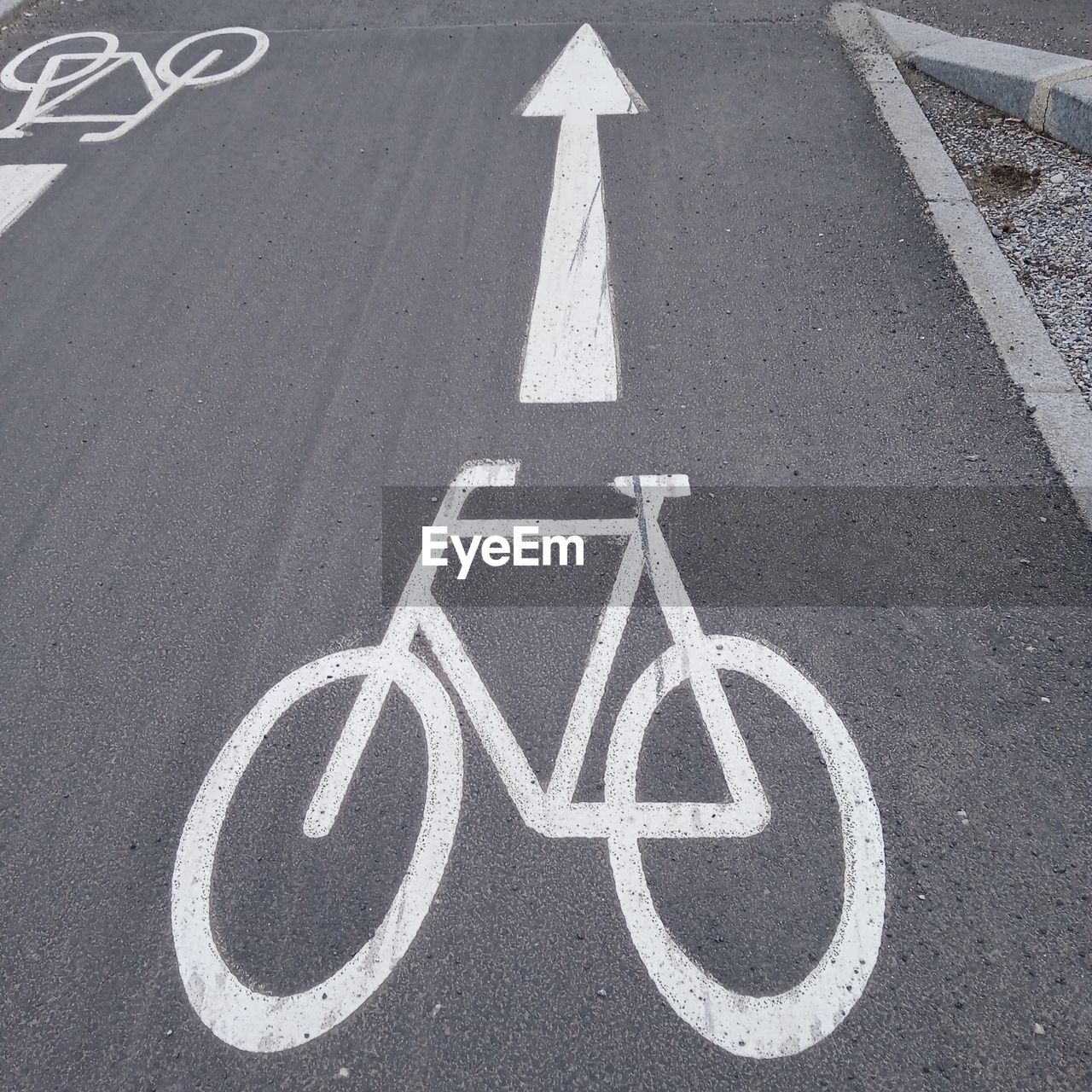 bicycle, sign, road, transportation, symbol, communication, lane, road marking, marking, guidance, city, road sign, bicycle lane, arrow symbol, no people, street, font, pedestrian crossing, white, day, asphalt, road surface, high angle view, line, zebra crossing, directional sign, tarmac, number, information sign, mode of transportation, human representation, representation, outdoors, the way forward, infrastructure